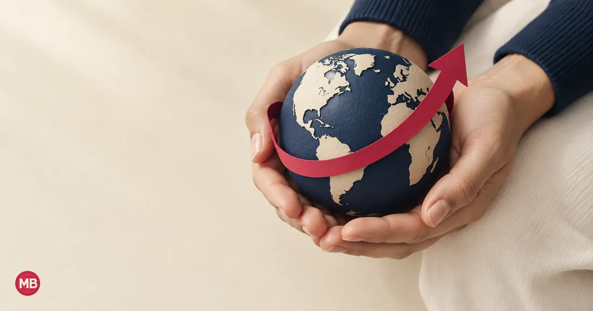 Two hands cupping a navy globe circled by a red arrow sweeping upward