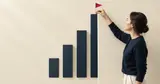 A woman planting a red flag on the tallest of a row of navy bars
