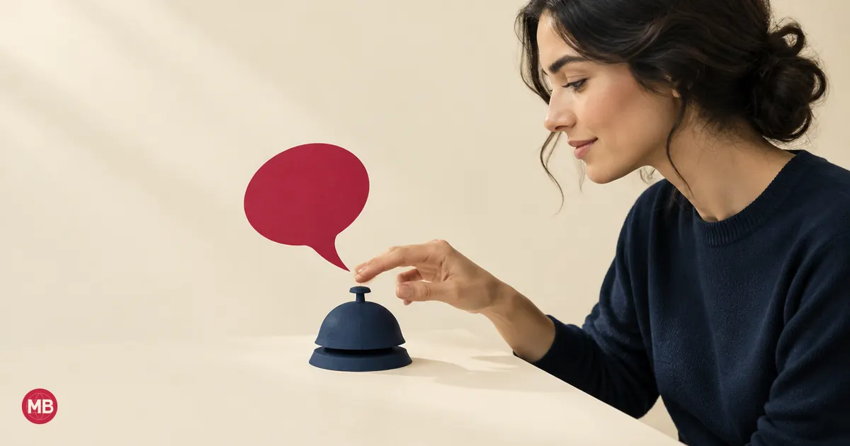 A woman in profile reaching for a navy desk bell as a red speech bubble rises from it